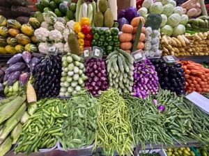 a display in a grocery store filled with lots of vegetables